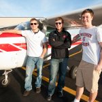 On April 26, 2010, University of Wisconsin-Madison undergraduates and members of the Flying Badgers aviation club Shawn Willette (left), Jason Muth (center) and Gregory Oudheusden (right) stand next to a single-propeller plane at the Dane County Regional Airport in Madison, Wisconsin. Oudheusden is the president and founder of the club. Willette has a license to be a private pilot, and friends in the club have drawn Muth to aviation. ©UW-Madison University Communications 608/262-0067 Photo by: Bryce Richter Date: 04/10 File#: NIKON D3 digital frame 1868