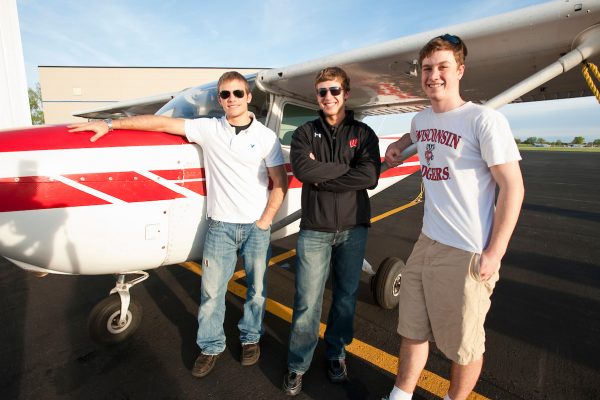 On April 26, 2010, University of Wisconsin-Madison undergraduates and members of the Flying Badgers aviation club Shawn Willette (left), Jason Muth (center) and Gregory Oudheusden (right) stand next to a single-propeller plane at the Dane County Regional Airport in Madison, Wisconsin. Oudheusden is the president and founder of the club. Willette has a license to be a private pilot, and friends in the club have drawn Muth to aviation. ©UW-Madison University Communications 608/262-0067 Photo by: Bryce Richter Date: 04/10 File#: NIKON D3 digital frame 1868